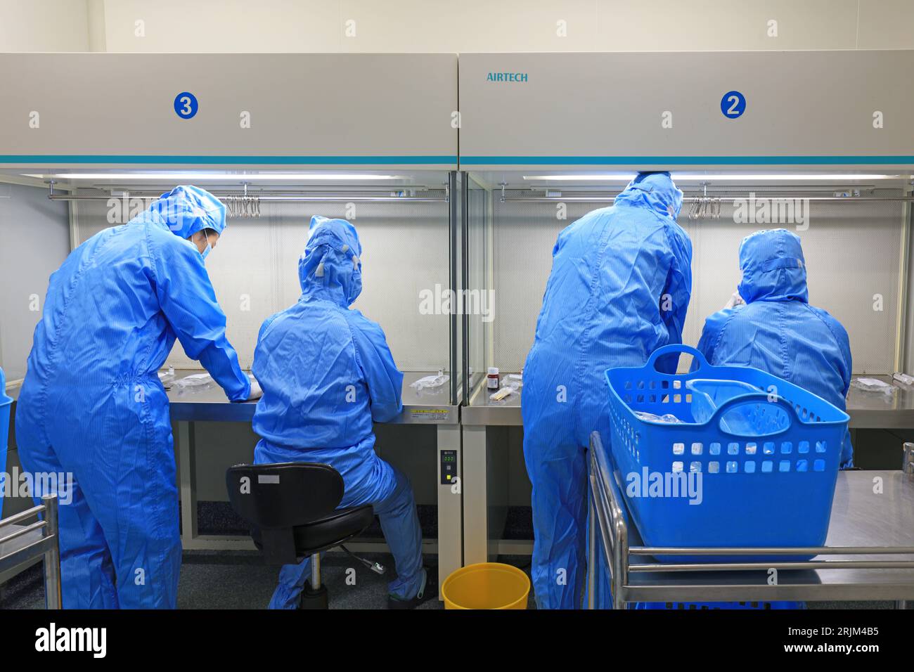 Medical workers dispense liquid in sterile room Stock Photo Alamy