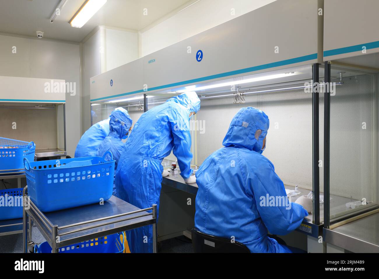 Medical workers dispense liquid in sterile room Stock Photo Alamy
