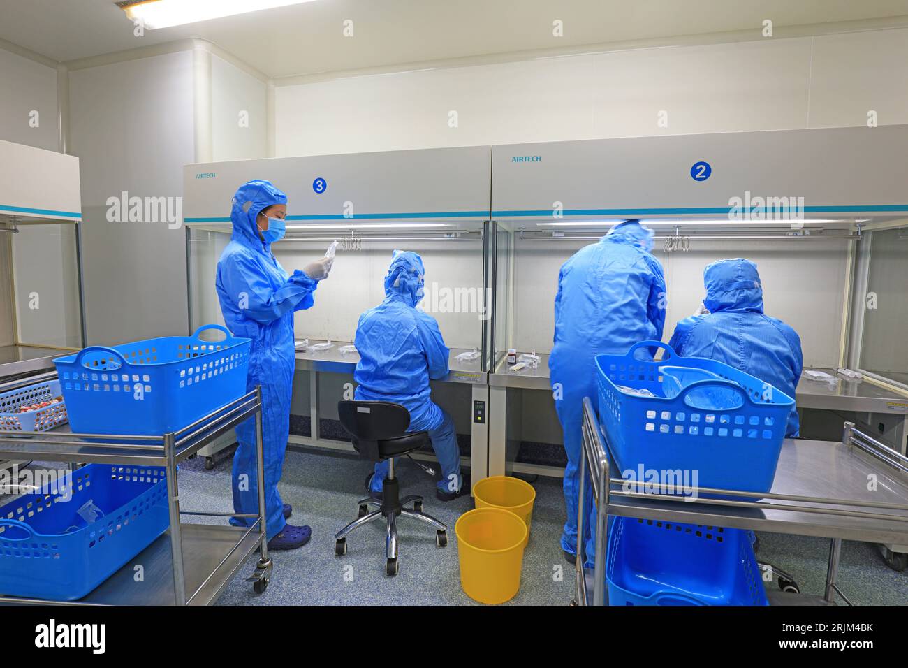 Medical workers dispense liquid in sterile room Stock Photo Alamy
