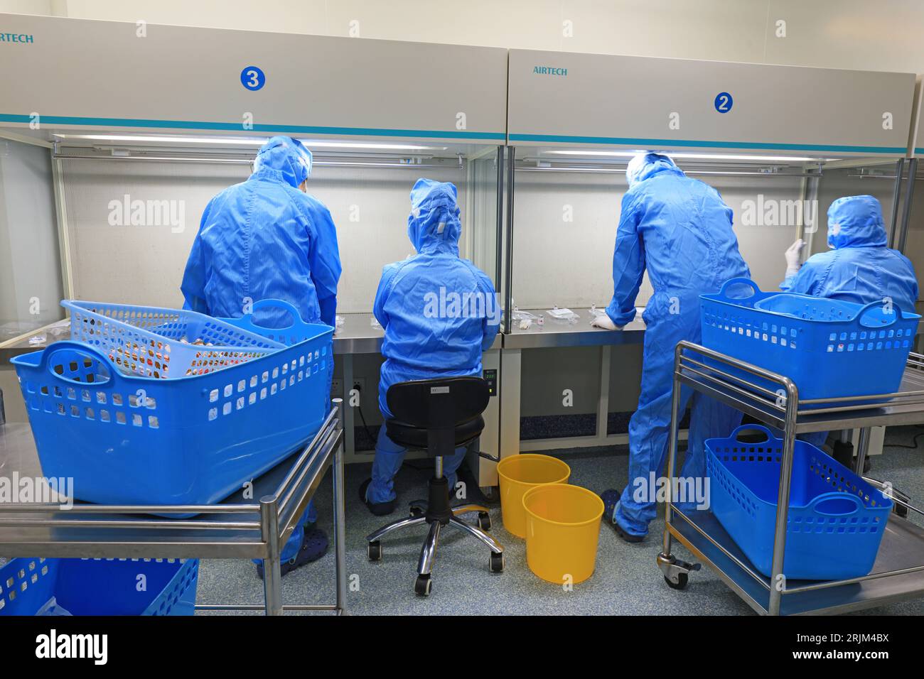 Medical workers dispense liquid in sterile room Stock Photo Alamy