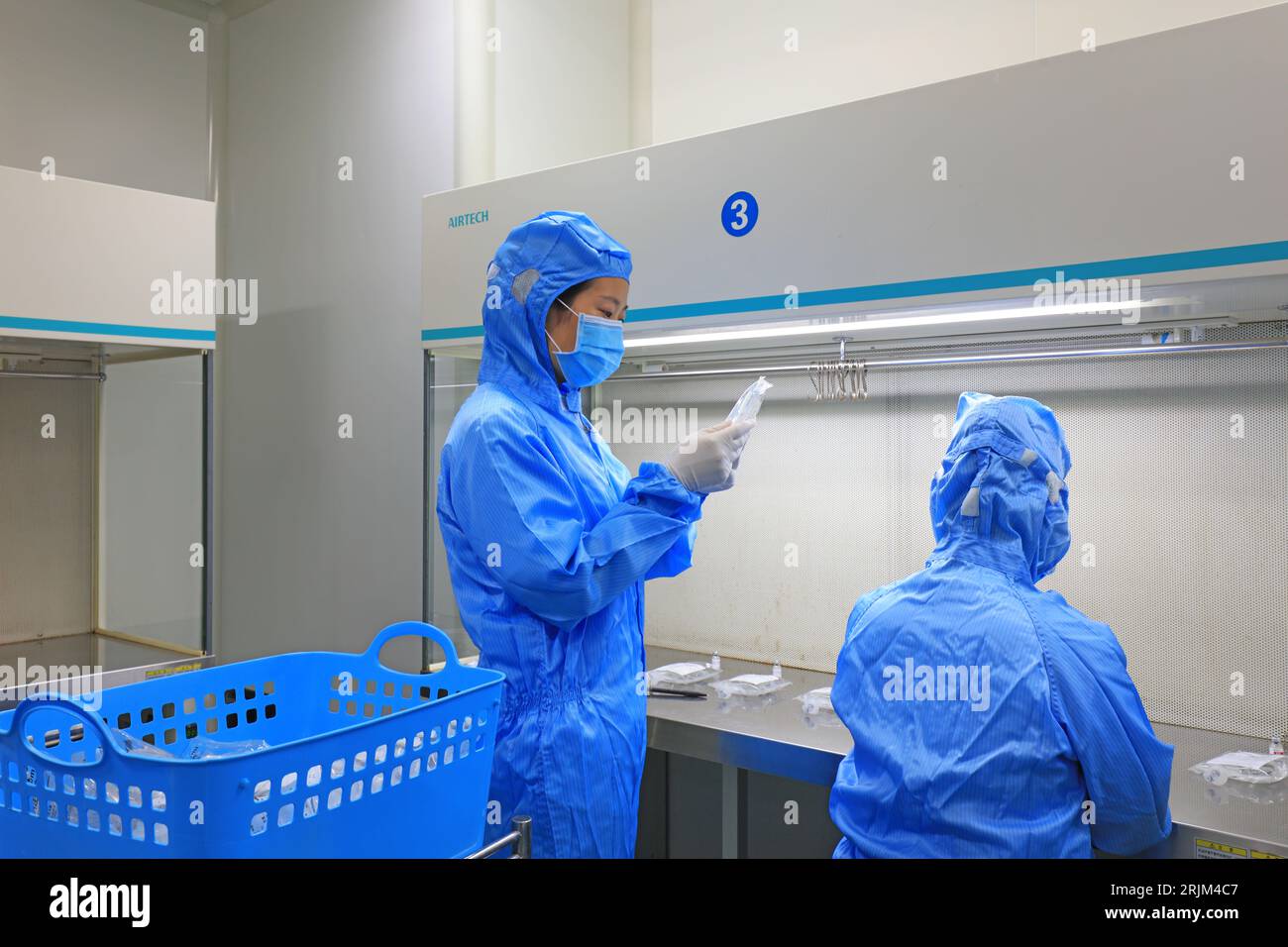 Medical workers dispense liquid in sterile room Stock Photo Alamy