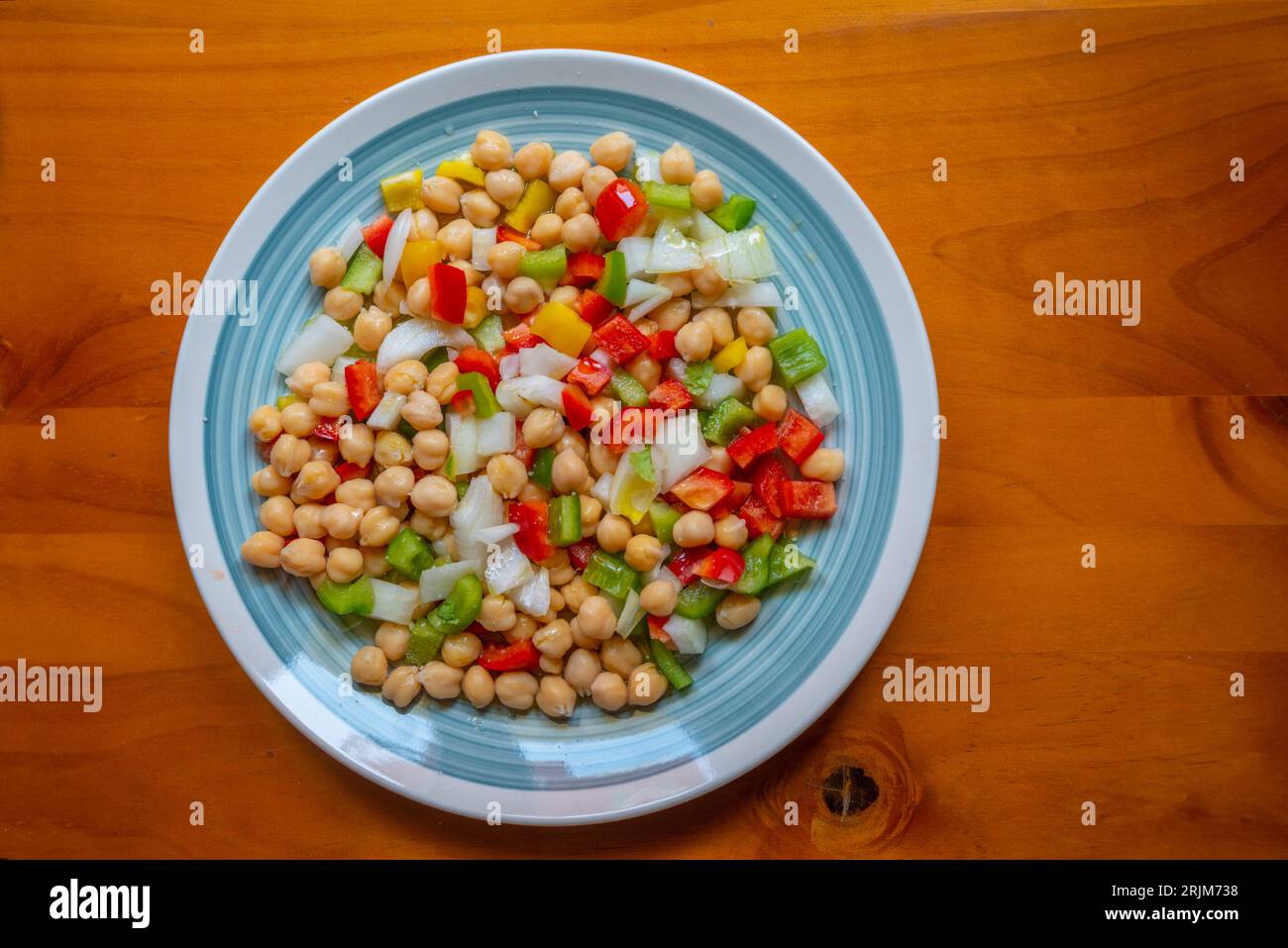 Salad made of chickpeas, pepper, onion and olive oil. Stock Photo