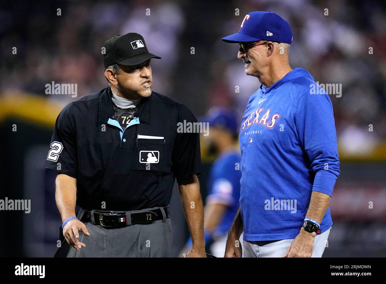 Texas Rangers pitching coach Mike Maddux talks with home plate umpire