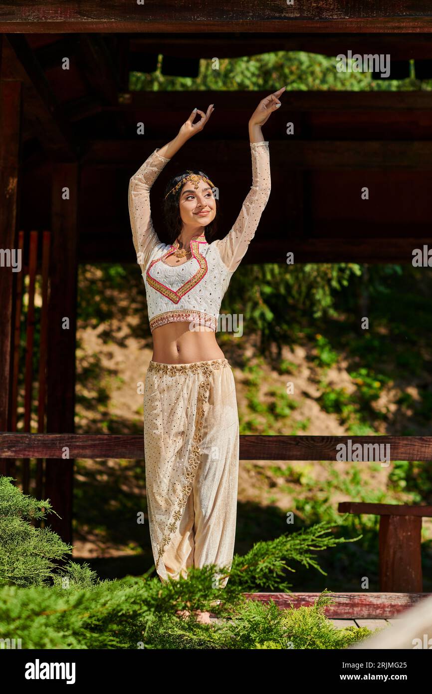 graceful indian woman in authentic style wear dancing in park, summer  enjoyment Stock Photo - Alamy, image size:866x1390