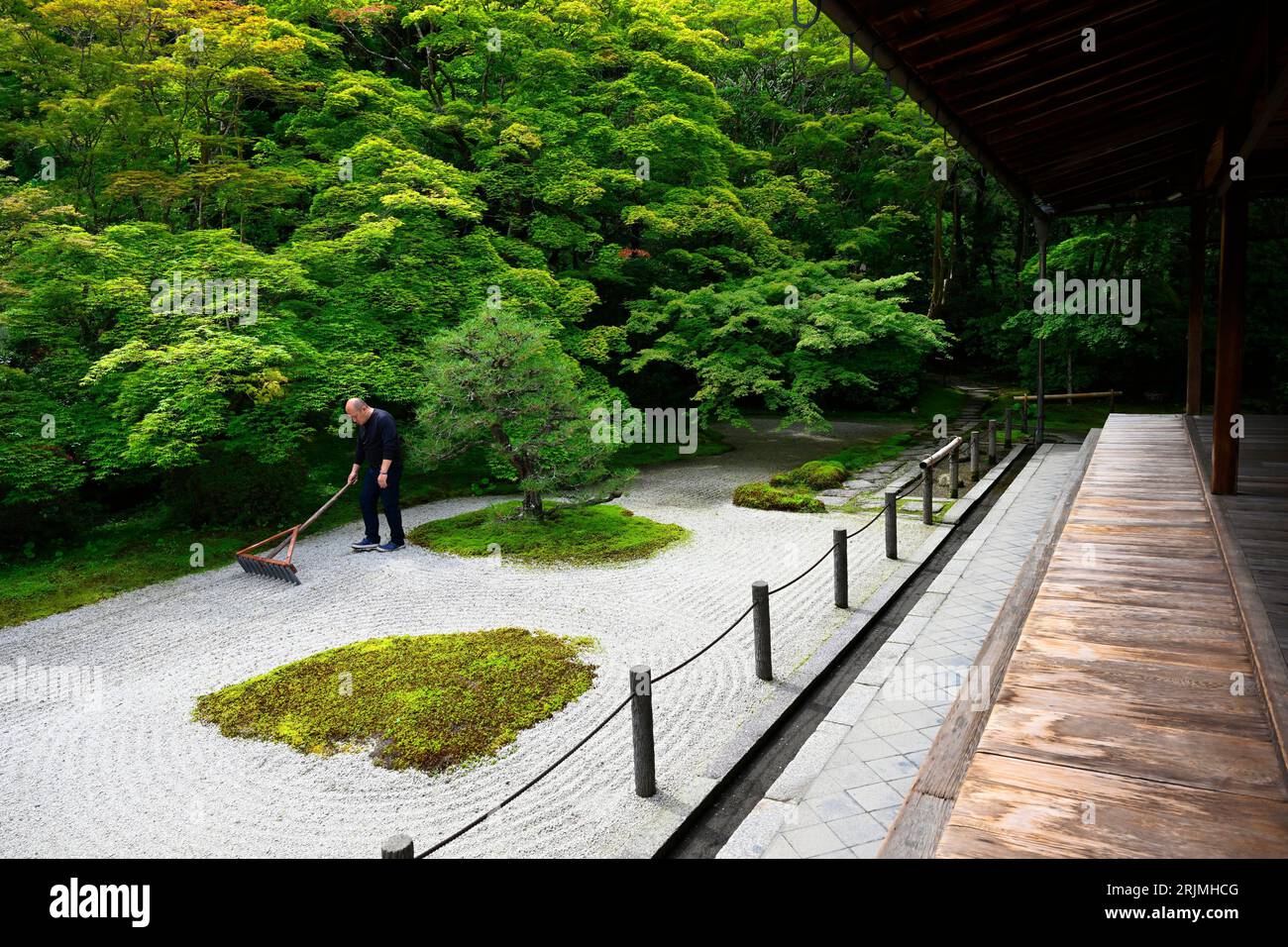 Buddhist monk raking the Zen garden of Tenjuan in the Nanzenji complex