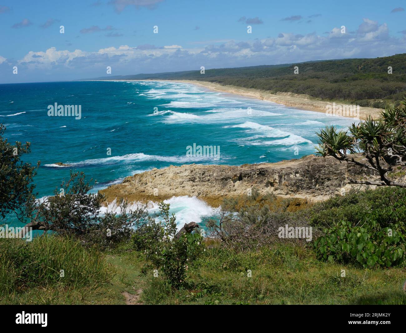 Main Beach surf beach Stradbroke Island Australia.  Summer day, blue skies and beautiful blue water, white topped waves. White sandy beach coastline Stock Photo