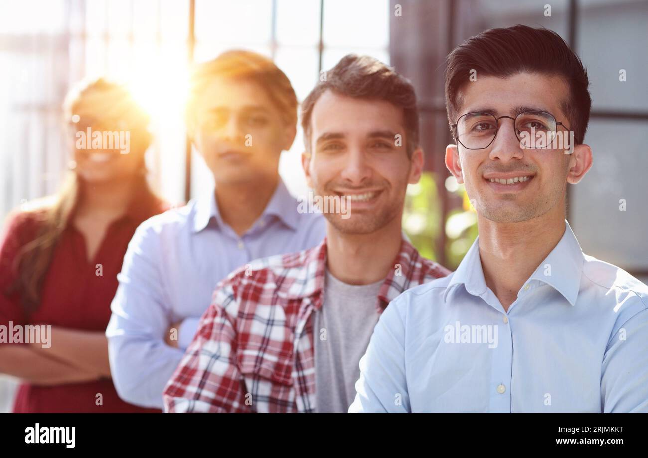 group of business people smiling in an office lined up Stock Photo - Alamy