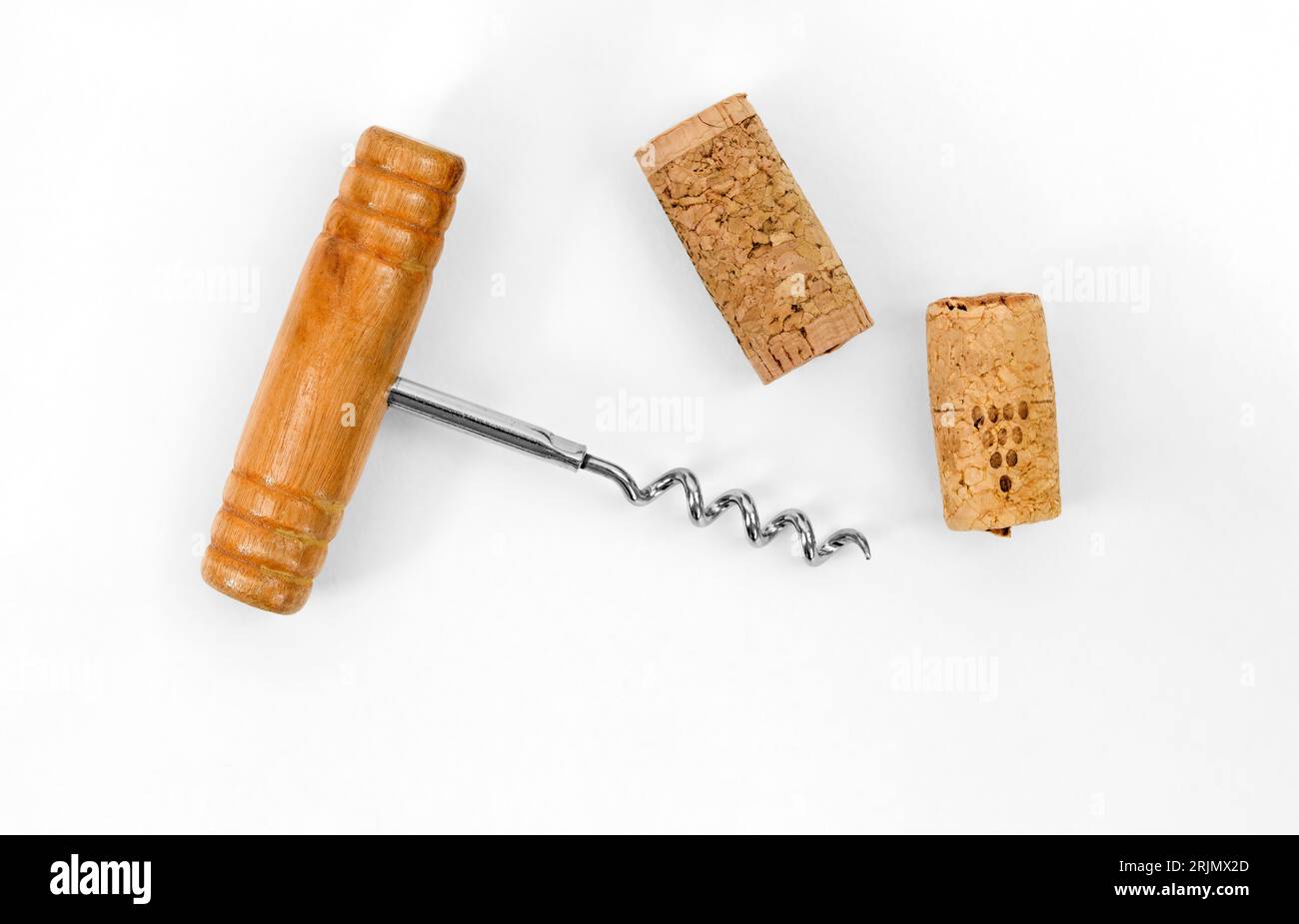 Bottle opener. Corkscrew with wooden handle and wine cork stopper isolated on white background with copy space. Stock Photo