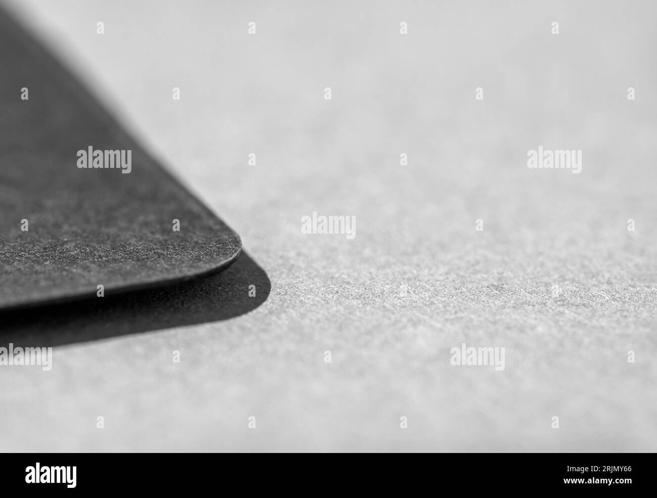 Photo of business card. Template for branding identity. Blank card. Black on grey, place for text. Close up. Stock Photo