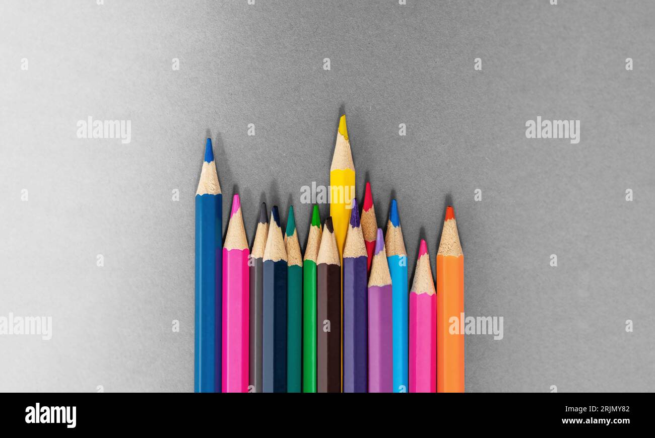 Standing Out From The Crowd concept. Colored pencils made with wood and with intense colours. Stock Photo