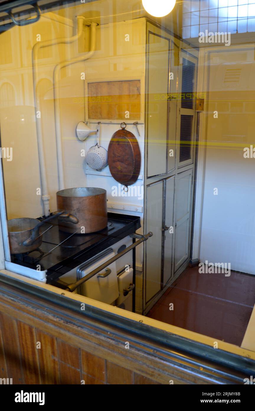 Kitchen of an old train and reflections of the station. The kitchen in