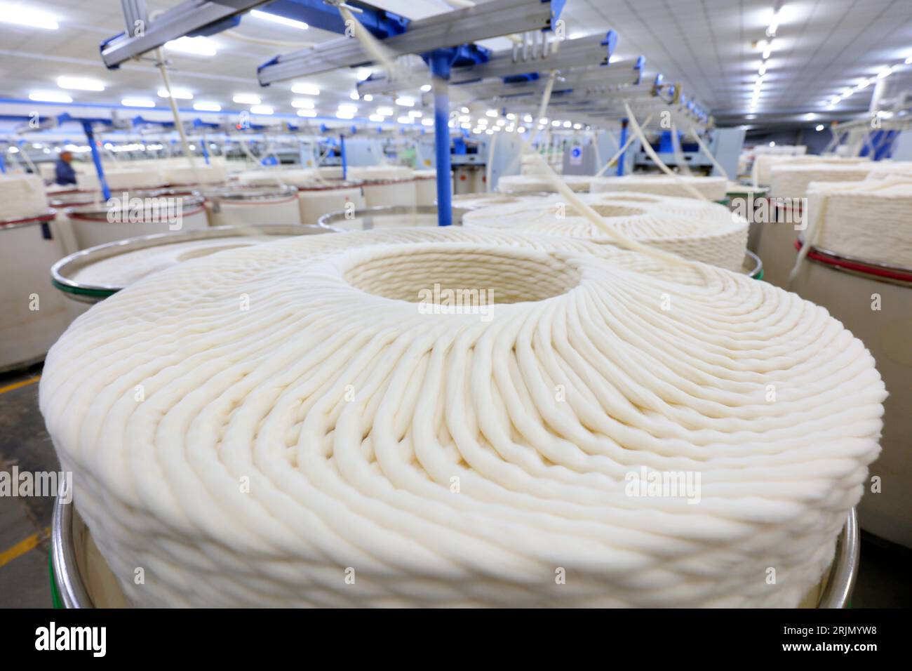 Cotton yarn on spinning line Stock Photo - Alamy