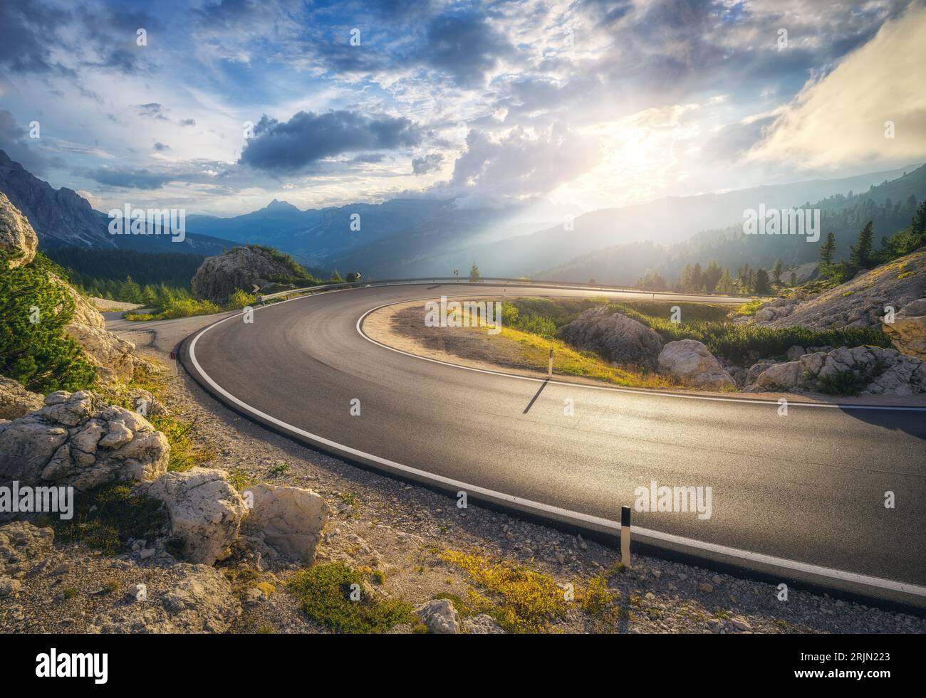 Mountain road at colorful sunset in summer. Curved roadway Stock Photo ...