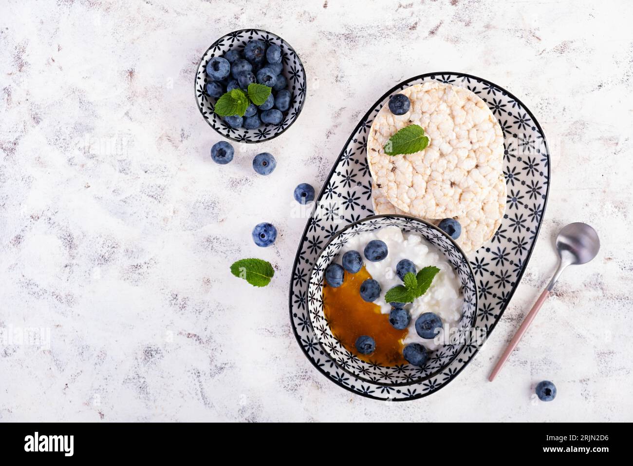Cottage cheese with honey and blueberries and rice cakes. Diet