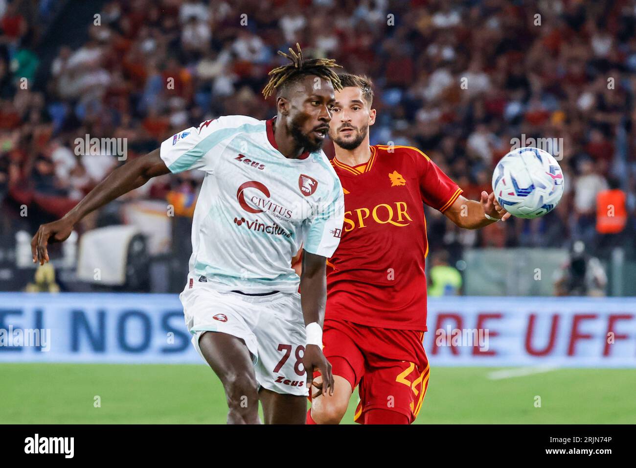 Rome, Italy, 20 August, 2023. Mamadou Coulibaly, left, of Salernitana, and Houssem Aouar, of AS Roma, fight for the ball during the Italian Serie A championship football match between Roma and Salernitana at the Olympic Stadium Stock Photo