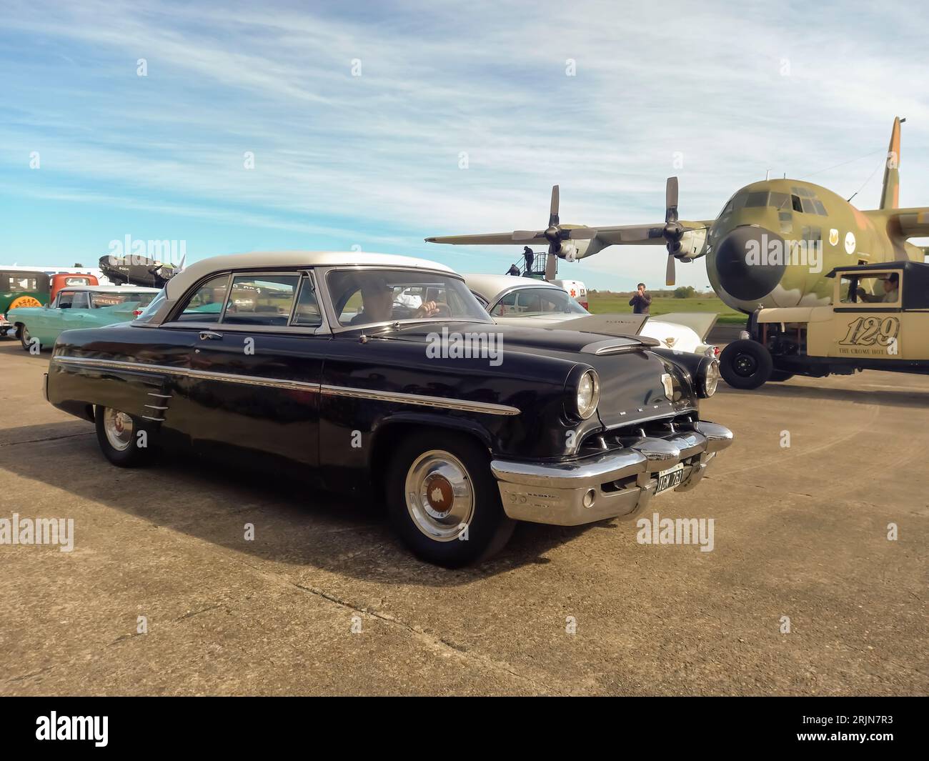 Old black 1953 Ford Mercury Monterey coupe hardtop at an airstrip. Classic car show. Sunny day. Copyspace Stock Photo