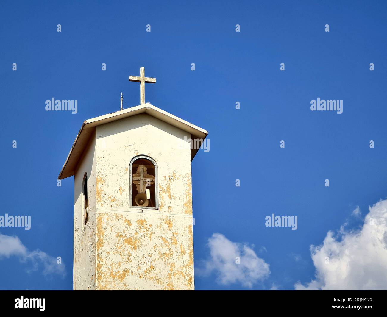 A church tower featuring a wooden cross on the top Stock Photo - Alamy