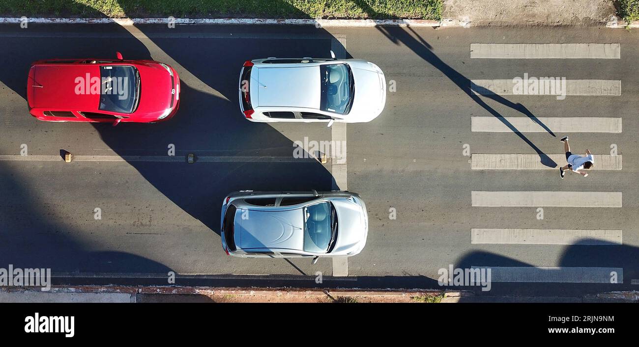 The cars on the road with a pedestrian crossing Stock Photo - Alamy