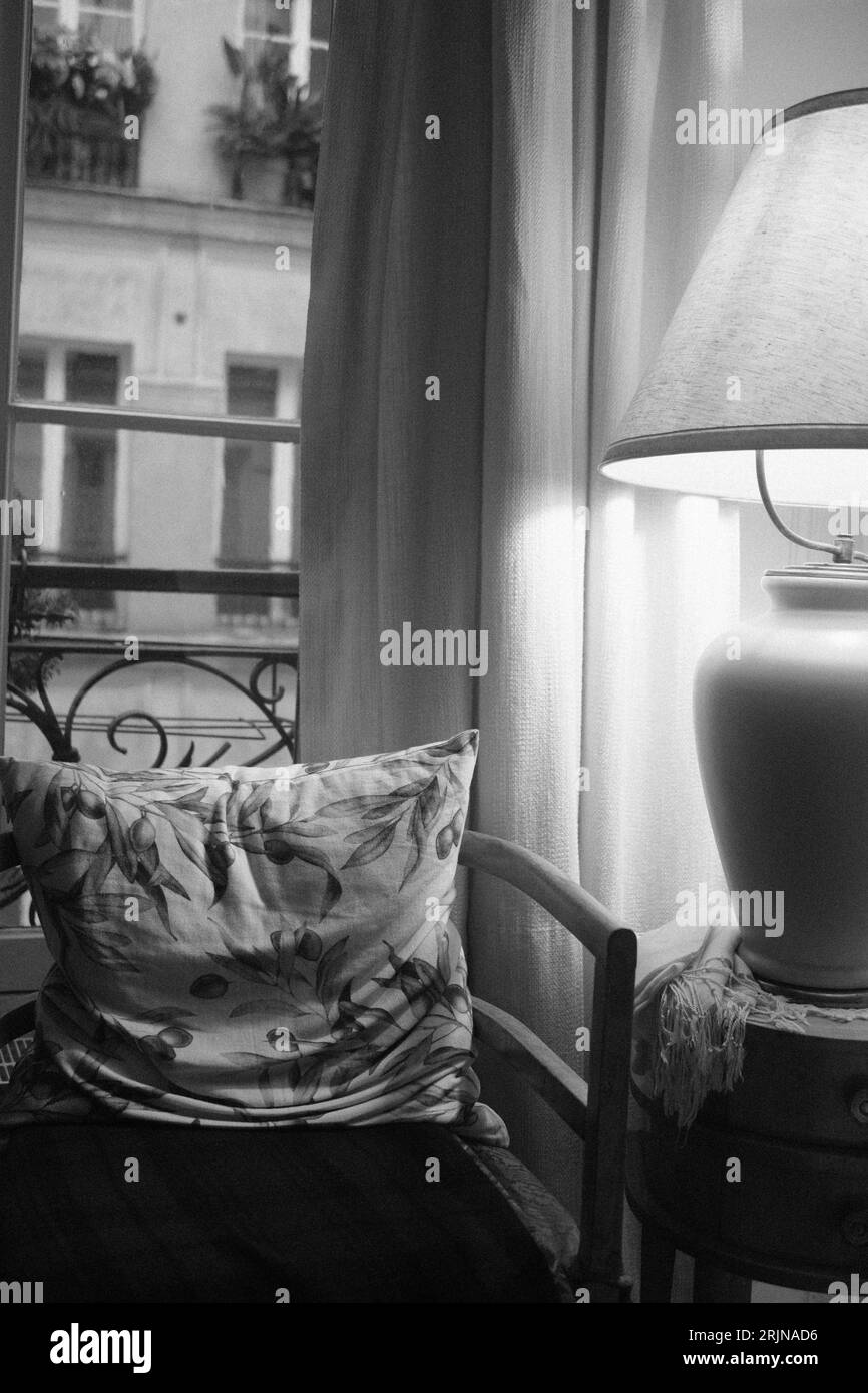 A monochromatic interior living space featuring a chair next to a table