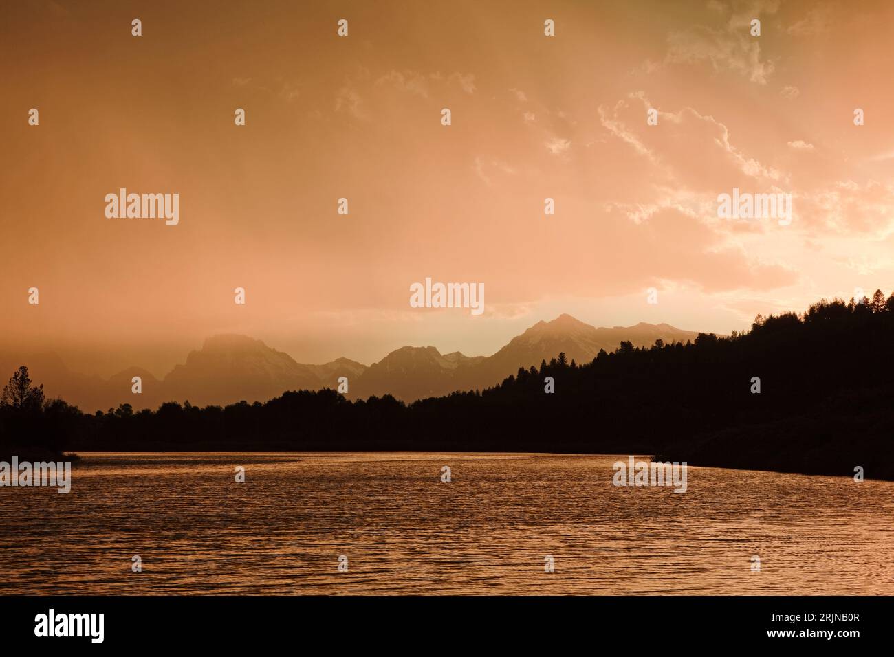 This is a view of a rainstorm at sunset  from the Oxbow Bend area of the Snake River in Grand Teton National Park, Wyoming. Stock Photo