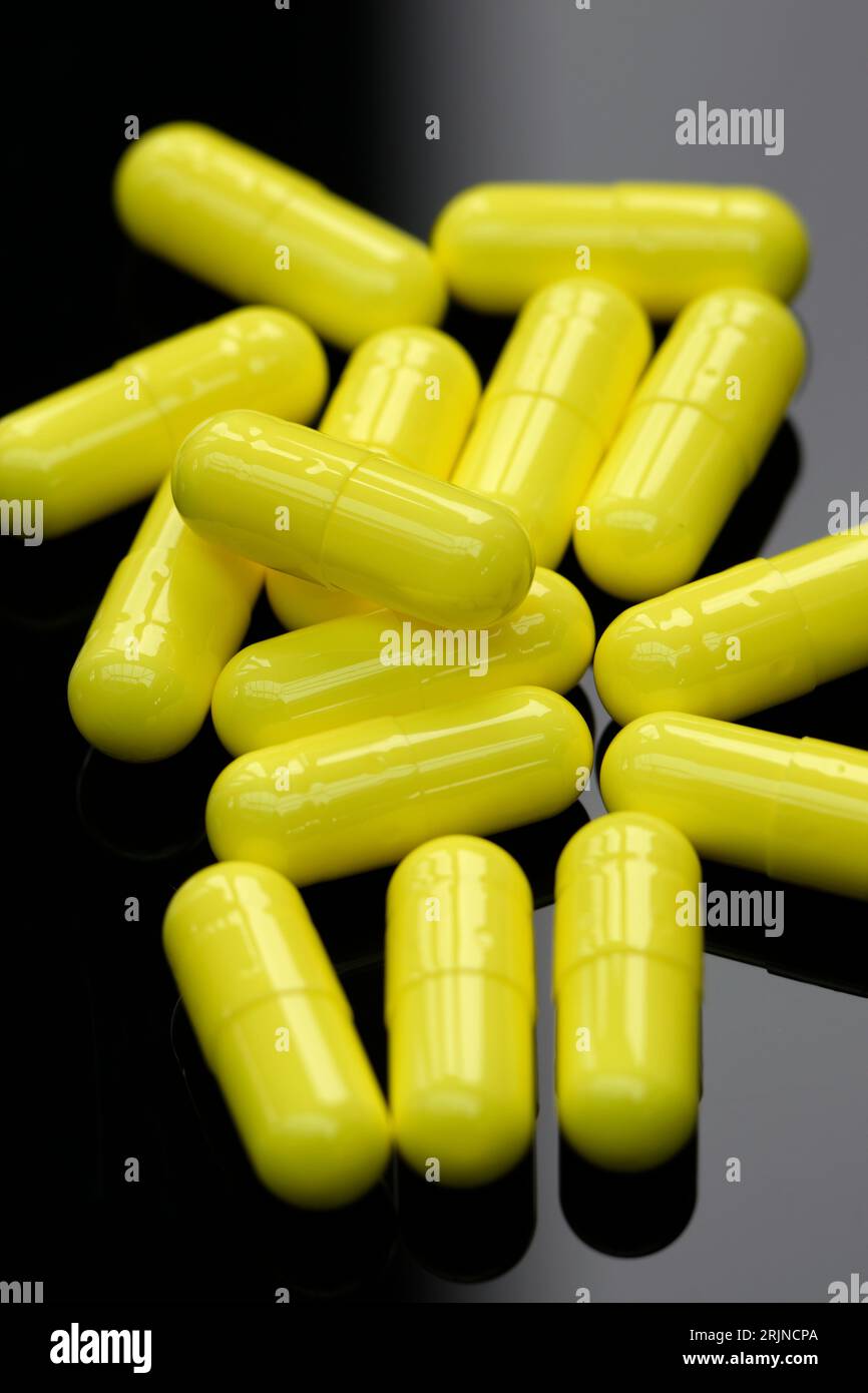 Yellow Medical capsules. Stock Photo