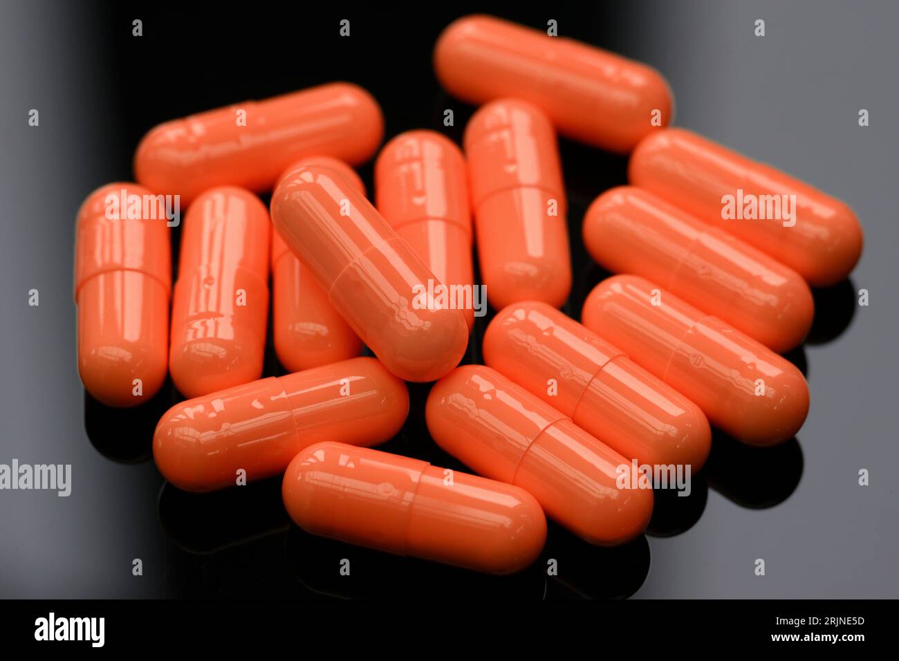 Orange Medical capsules. Stock Photo
