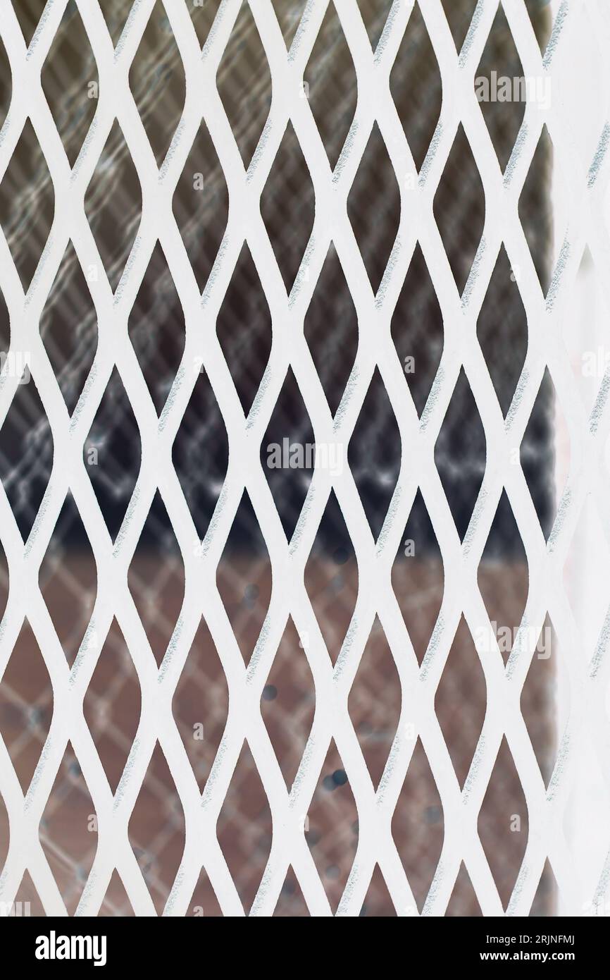 A common industrial chain link metal fence with a repeating pattern in ...
