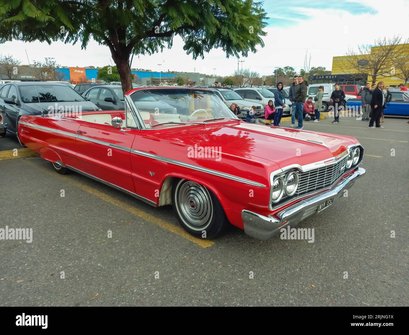 old red 1964 Chevrolet Chevy Impala SS Super Sport V8 two door convertible by GM in a parking lot. Classic car show Stock Photo