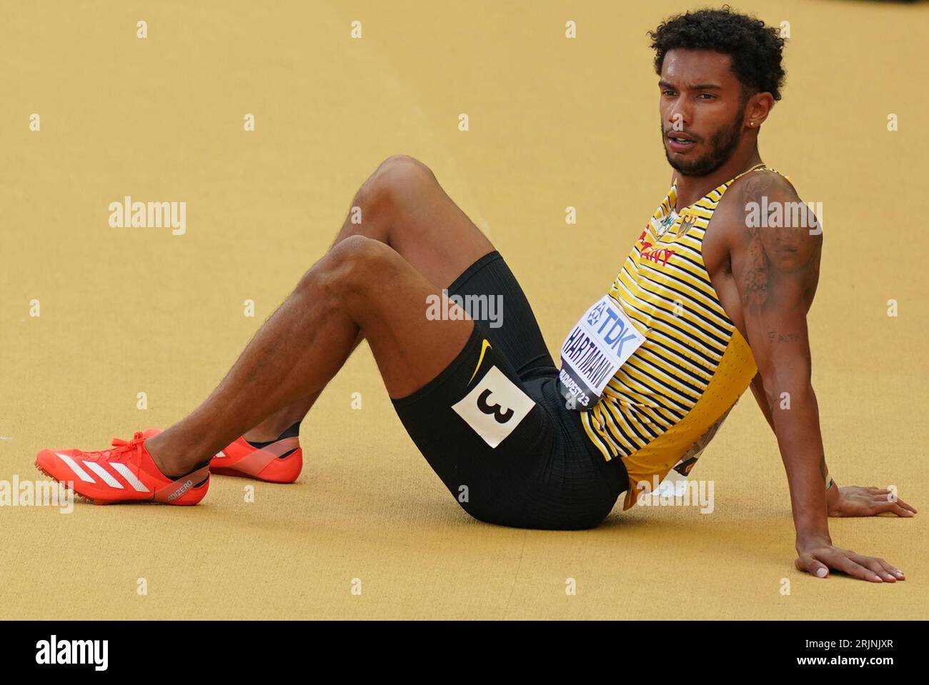 Budapest, Hungary. 23rd Aug, 2023. Athletics: World Championships, 200 m, preliminary heat, men, at the National Athletics Center. Joshua Hartmann (Germany) sits disappointed on the track. Credit: Marcus Brandt/dpa/Alamy Live News Stock Photo