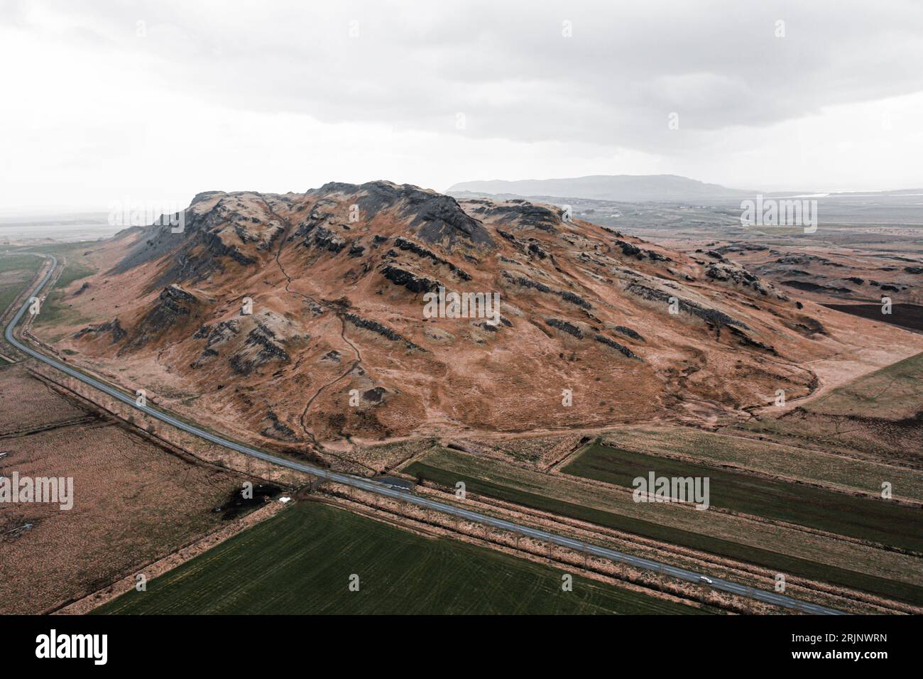 An aerial view of a winding road cutting through the arid desert ...