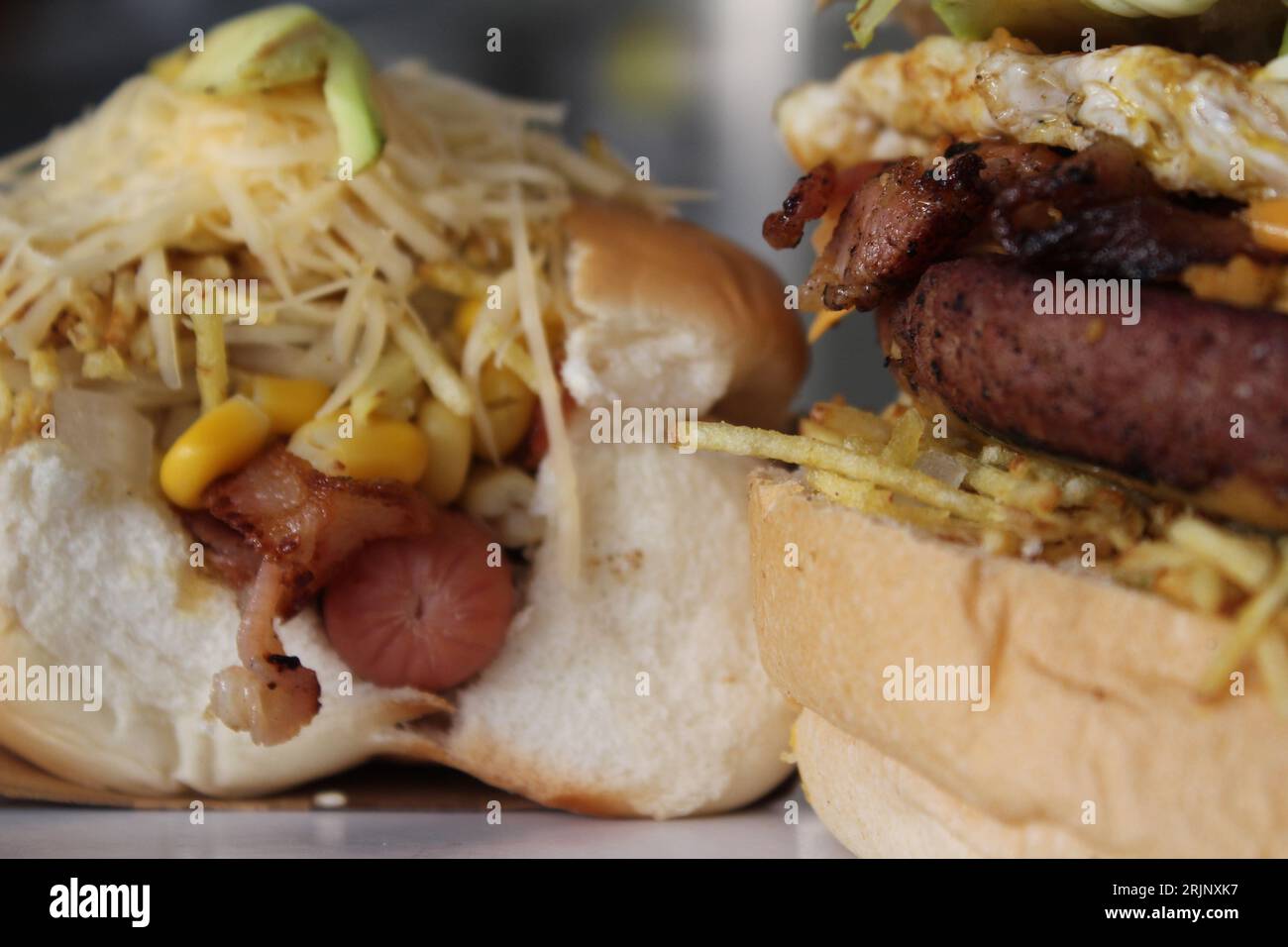 A closeup of a freshly-made burger and a hot dog Stock Photo