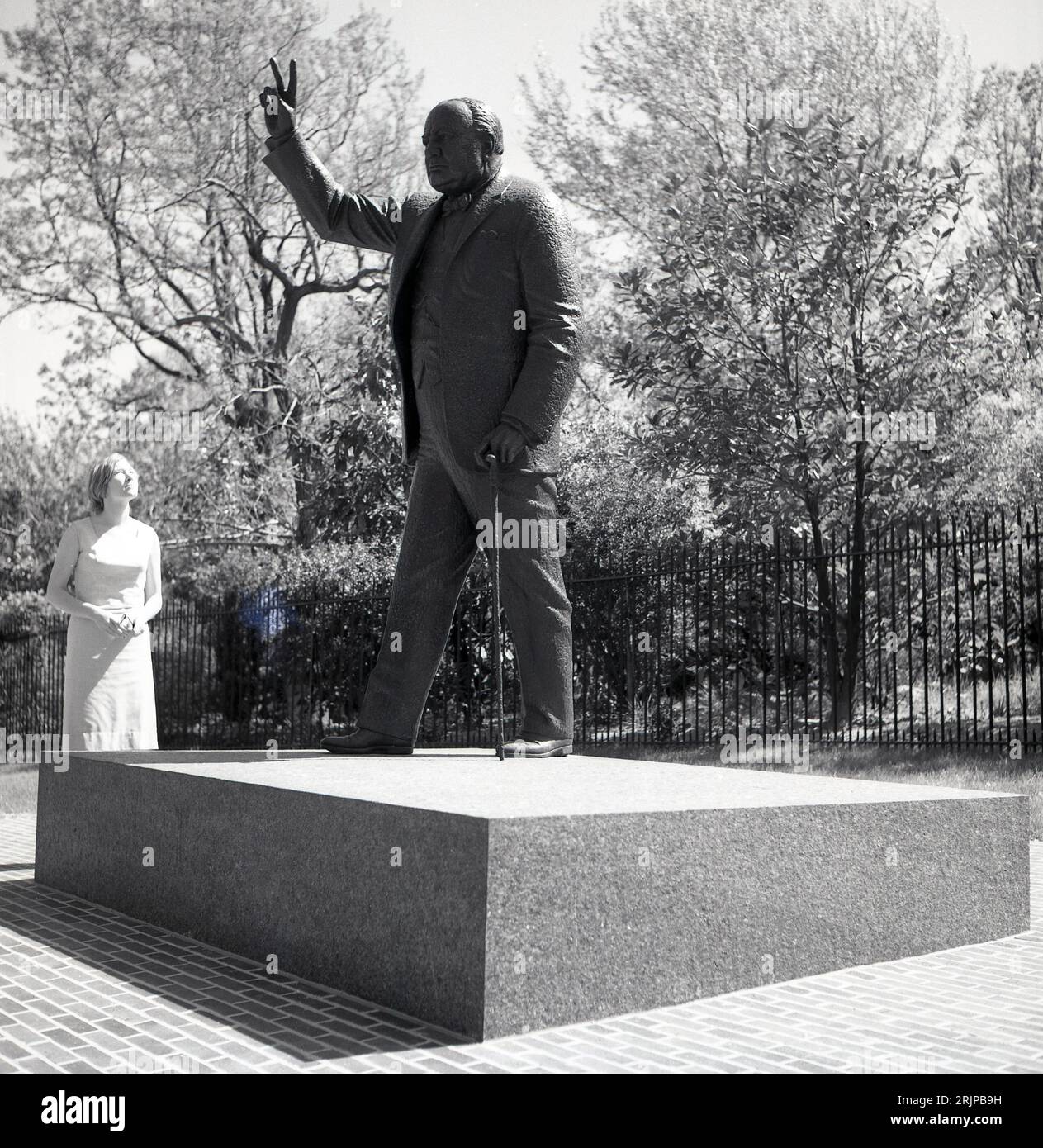 1960s, historical, Washington DC, USA, summertime and a lady looking at the bronze sculpture of
