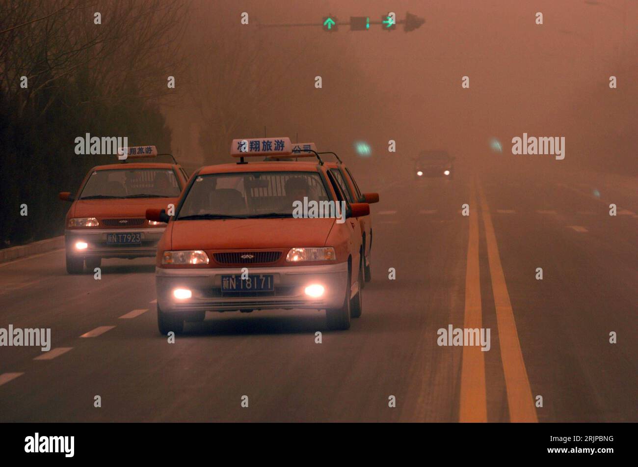 Bildnummer: 51145969  Datum: 12.03.2006  Copyright: imago/Xinhua Taxen mit Licht unterwegs auf einer Straße während eines Sandsturms in Kuqa -  Xinjiang Uygur Chinas - PUBLICATIONxNOTxINxCHN, Objekte; 2006, Kuqa, Sandsturm, Sandstürme, Stürme , Taxi, Auto, Autos, PKW, PKWs, Nebelscheinwerfer, Scheinwerfer, leuchten, leuchtet, leuchtend; , quer, Kbdig, Gruppenbild, China,  , Straße, Verkehr, Stock Photo