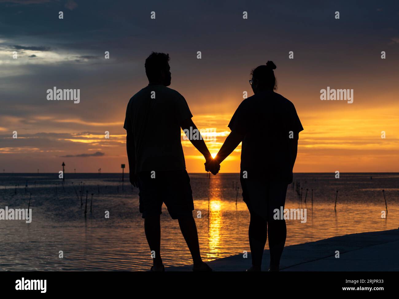 Indian couple holding hands silhouette hi-res stock photography and ...