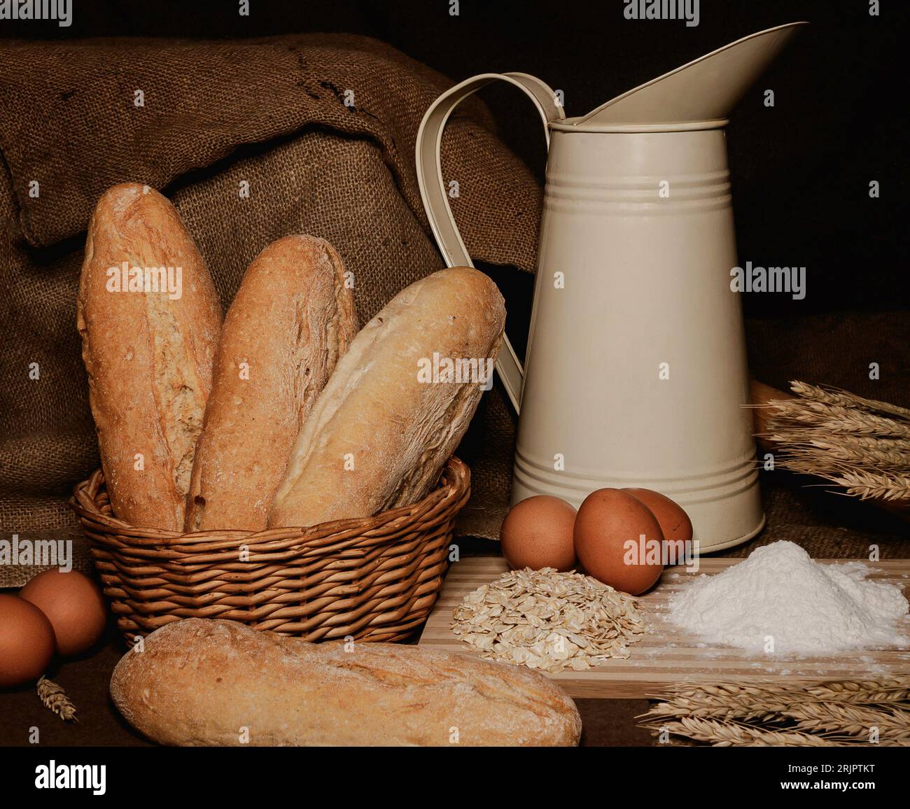 Rustic farmhouse bread, eggs and milk display Stock Photo