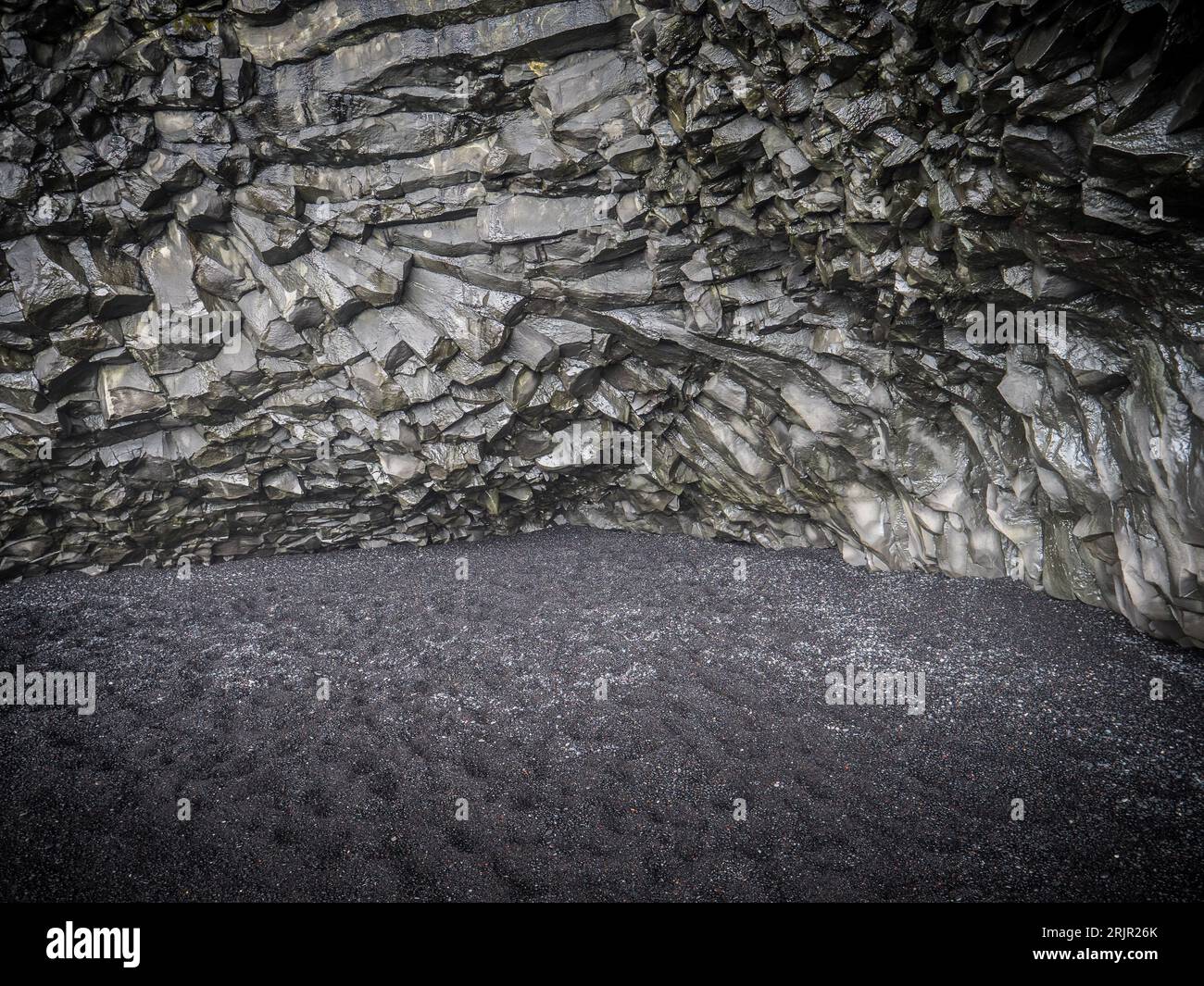 Photo of a stunning rock formation against the backdrop of Iceland's black floor Stock Photo