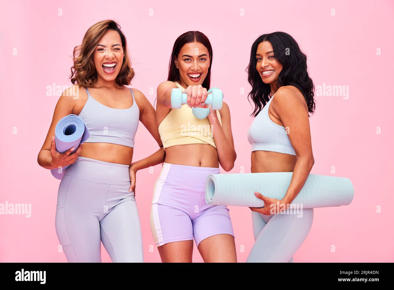 Three young women laughing and smiling in gym Stock Photo - Alamy