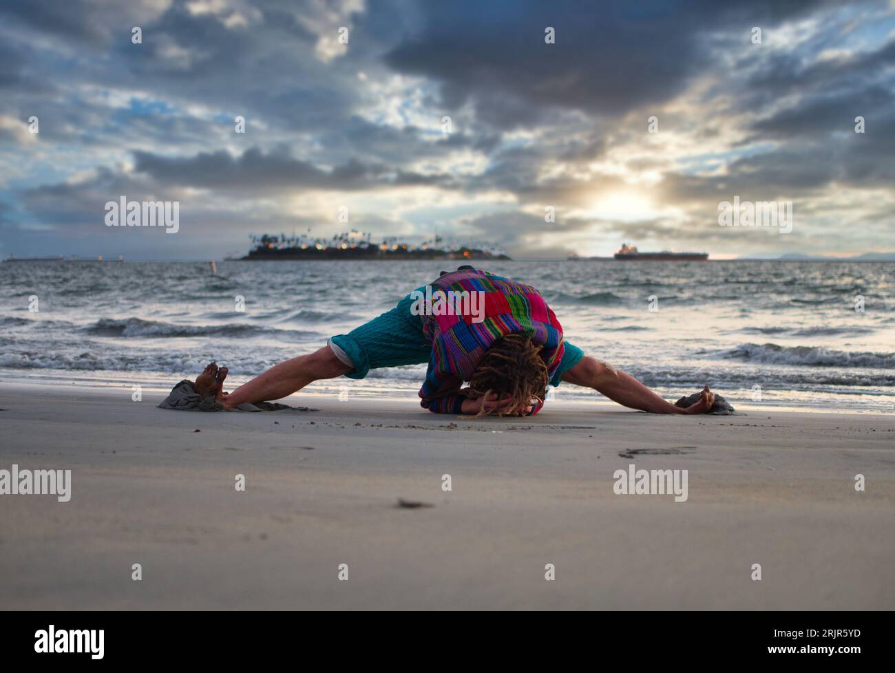 Photo of a person bending over on the beach Stock Photo Alamy