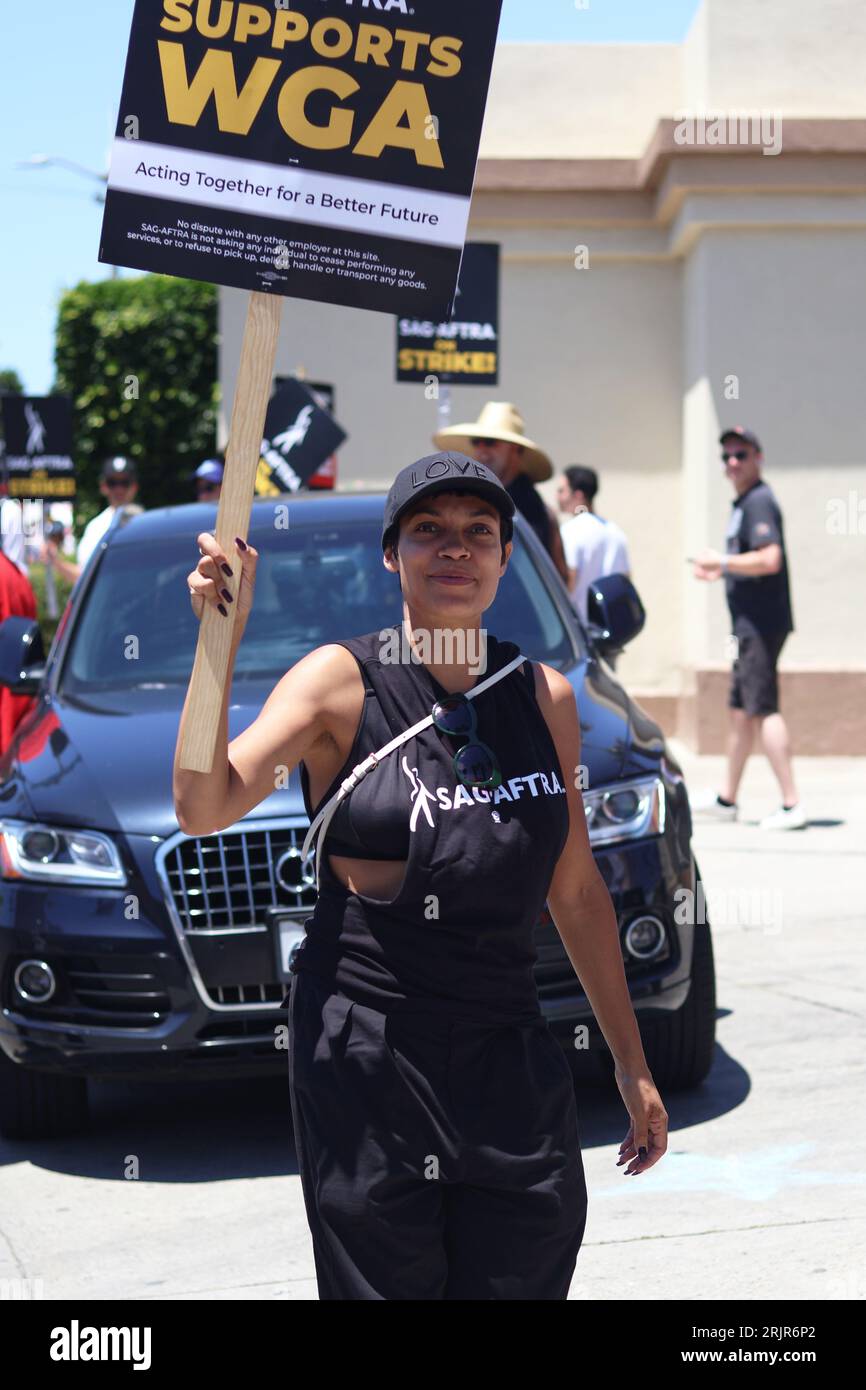 Rosario Dawson is captured walking in solidarity with members of two unions, SAG-AFTRA and WGA, during a protest outside Paramount studios Stock Photo
