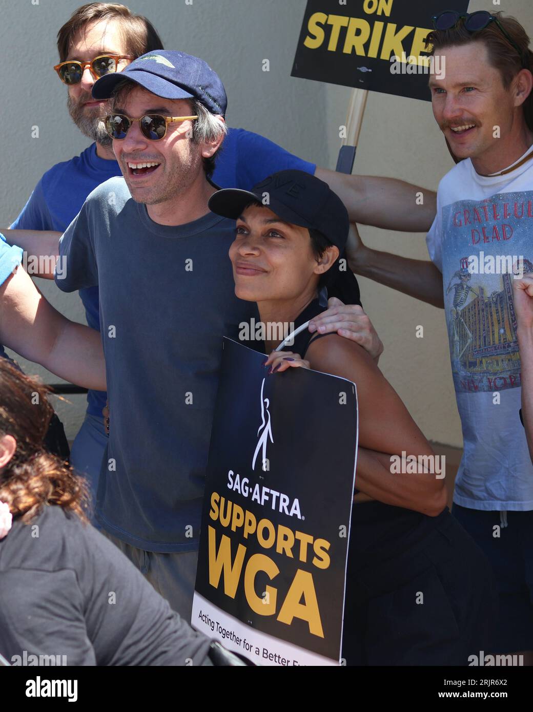 Rosario Dawson is captured walking in solidarity with members of two unions, SAG-AFTRA and WGA, during a protest outside Paramount studios Stock Photo