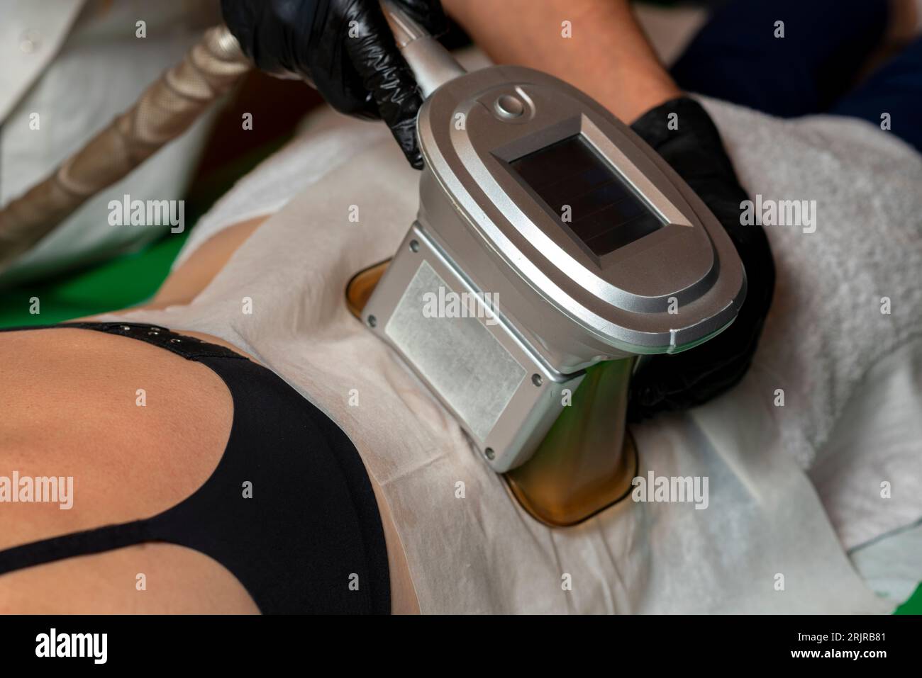 A young female receiving a beauty and skin care treatment in a spa, lying on a massage table Stock Photo