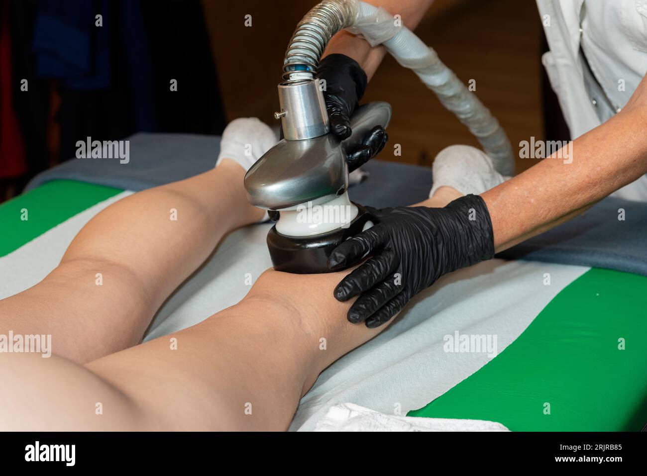 A young female receiving a beauty and skin care treatment in a spa, lying on a massage table Stock Photo