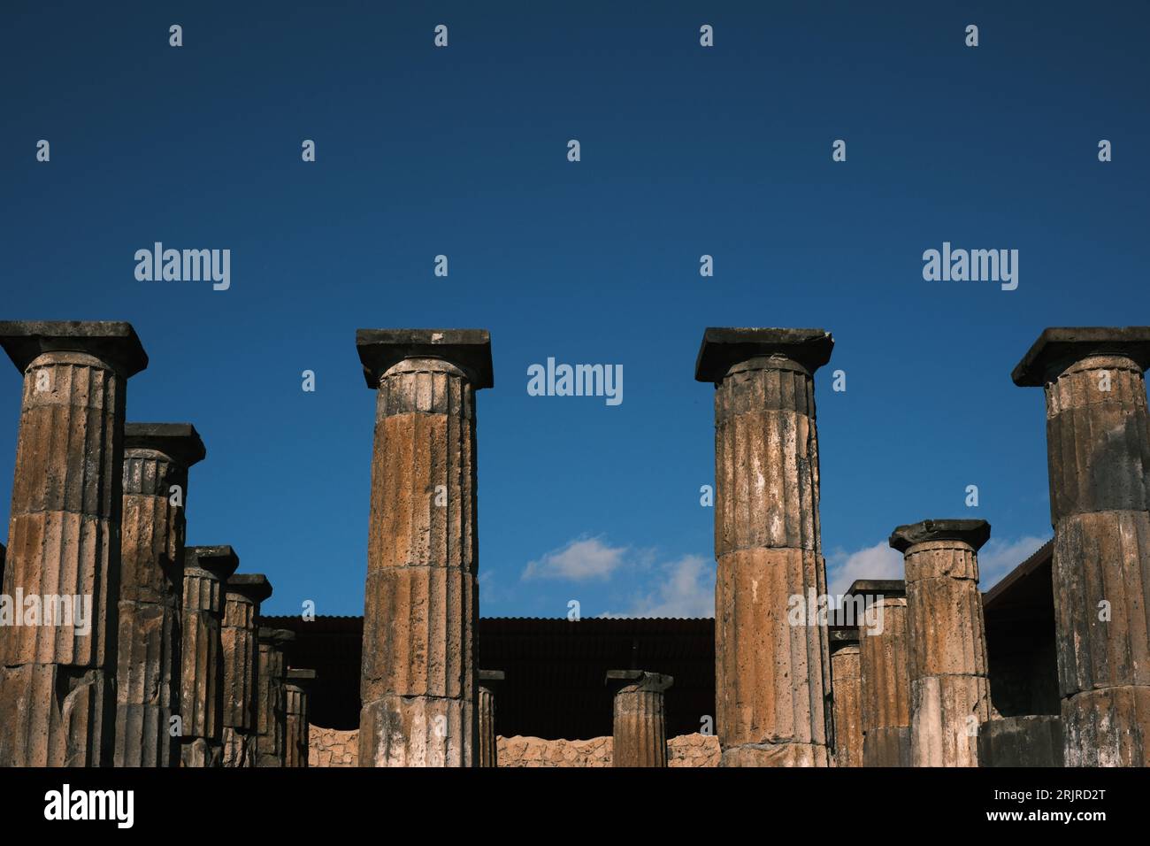 Three tall architectural columns standing side by side in a row near the ground Stock Photo Alamy