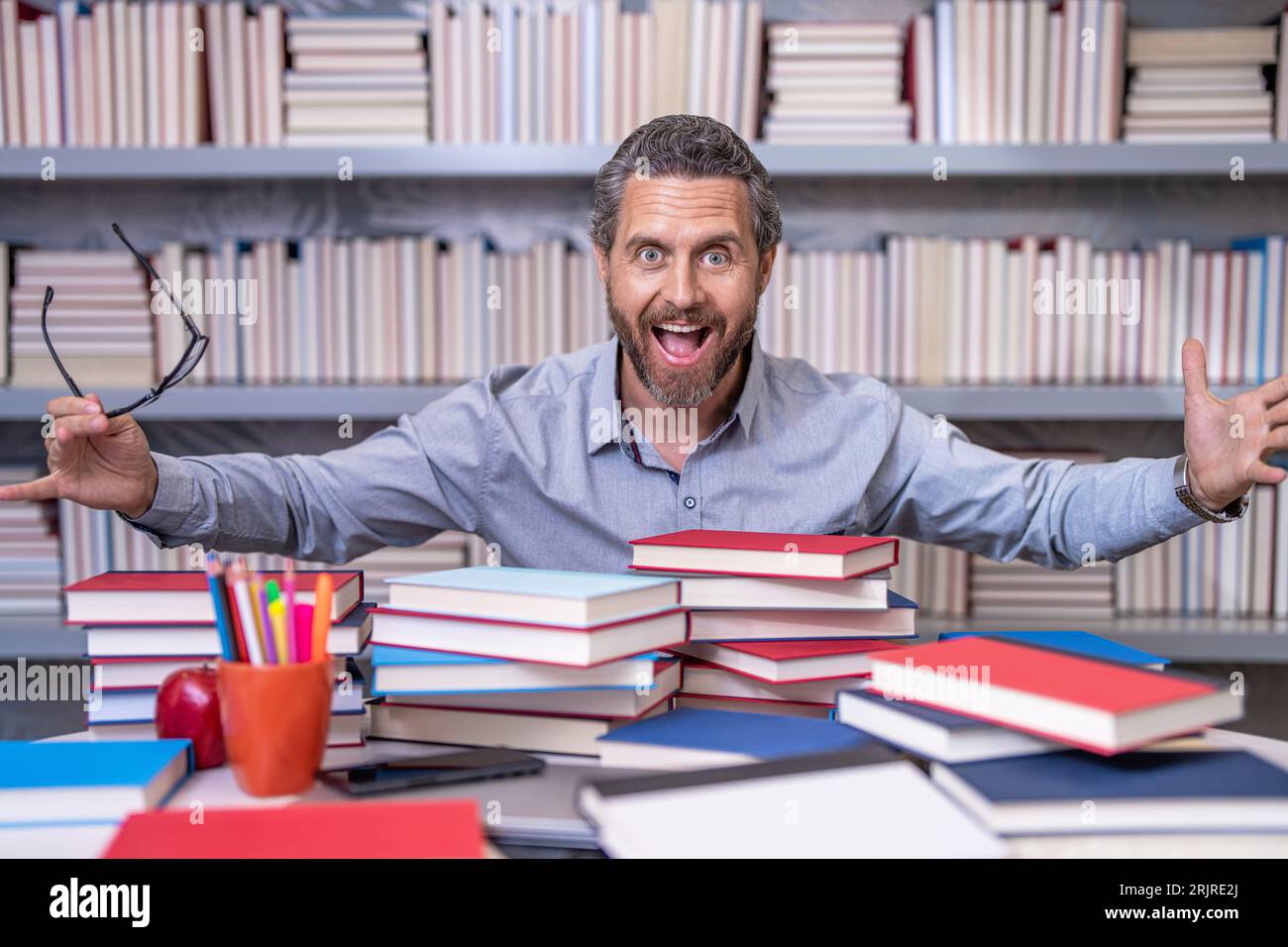 school teacher improve education in library. knowledge day. teacher prepare for school exam. overworked professor at lesson. school professor with boo Stock Photo