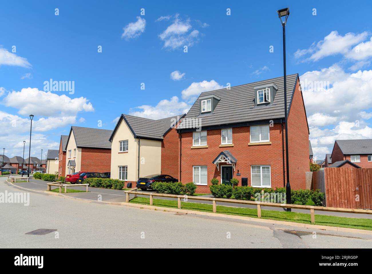 New bick detached houses in housing devlopment on a clear summer day Stock Photo