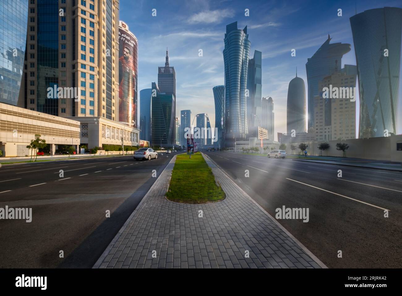 A picturesque photo captures the stunning Qatar Corniche road in all its glory during the FIFA World Cup. The winter afternoon sun casts an awesome sp Stock Photo