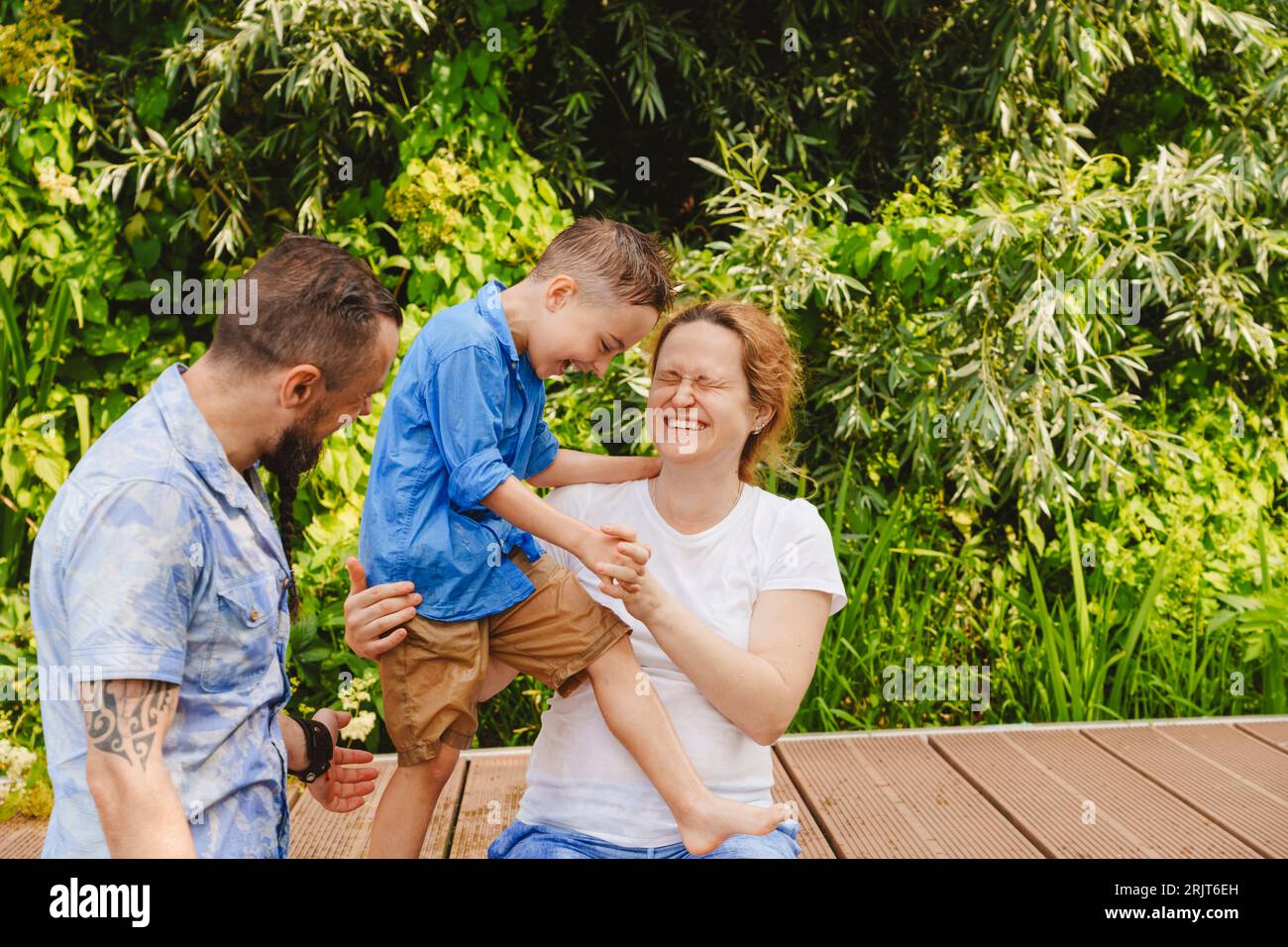 Happy family spending leisure time on footbridge Stock Photo