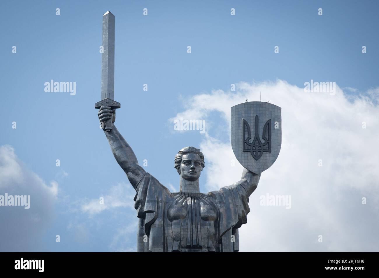 Motherland monument with the new Ukrainian coat of arms on the shield
