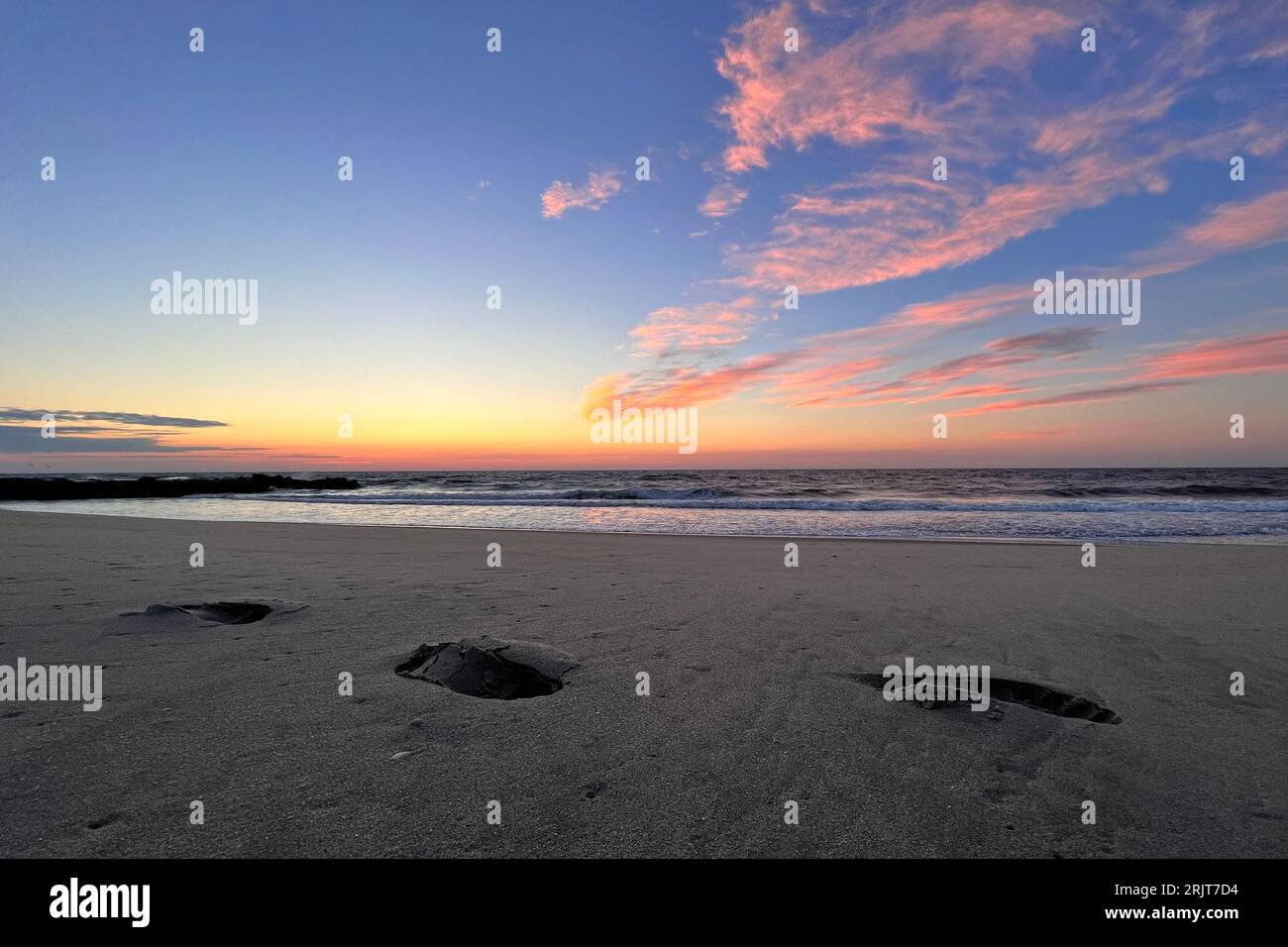 Bradley Beach, United States. 23rd Aug, 2023. Clouds in the sky light up as the sun approaches its rise over the horizon at the start of a new summer day, at the Atlantic Shore of New Jersey, United States, on August 23, 2020. Credit: OOgImages/Alamy Live News Stock Photo