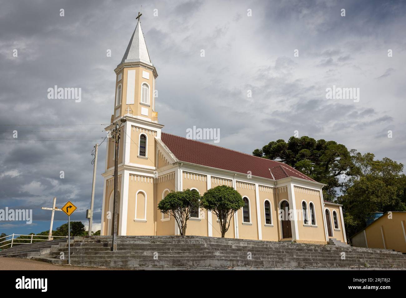 A white church with an impressive arched steeple and a tall tower Stock Photo